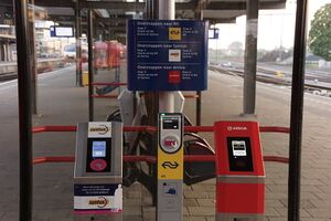 3 OV-Chipkaart readers next to each other. They each have distinctive colors and marking to indicate that they are for different modes of transport.